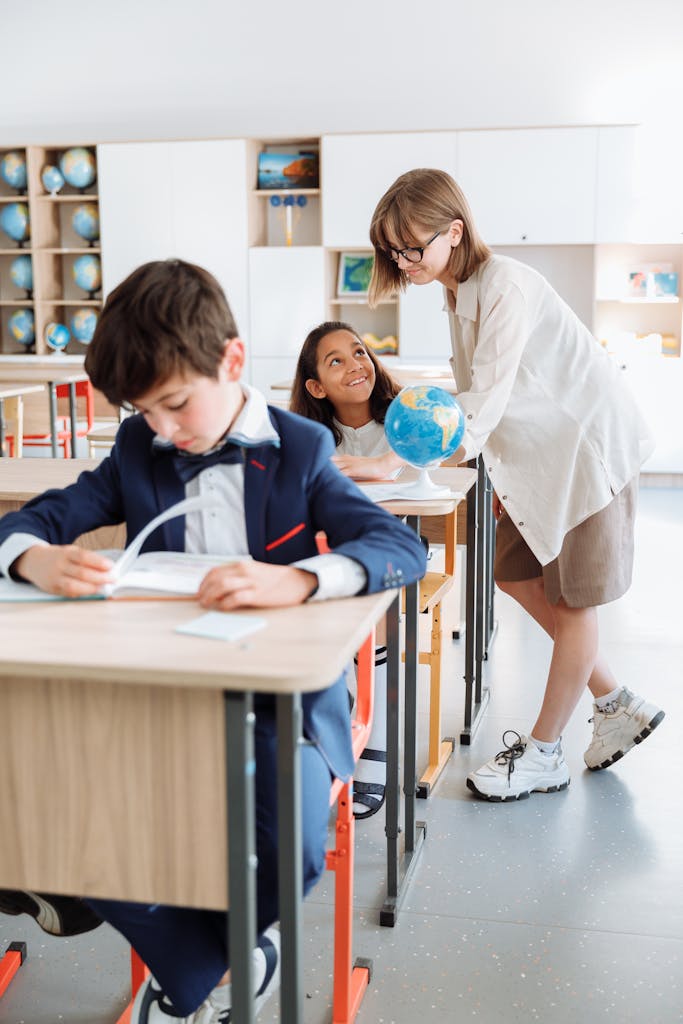 Children learning geography with a globe in a classroom.